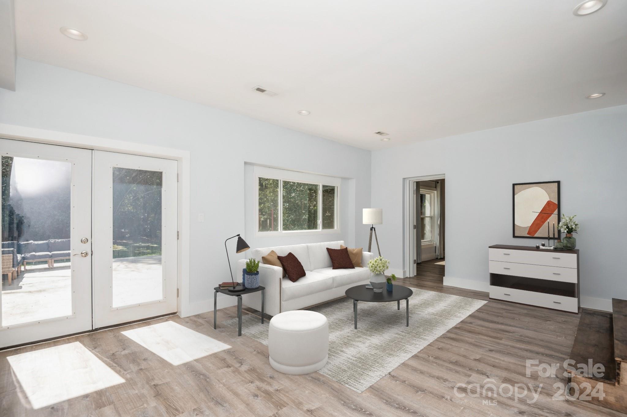 2124 Tyvola Road Charlotte, NC 28210 - Photo 8 of 38 a living room with furniture a wooden floor and a large window