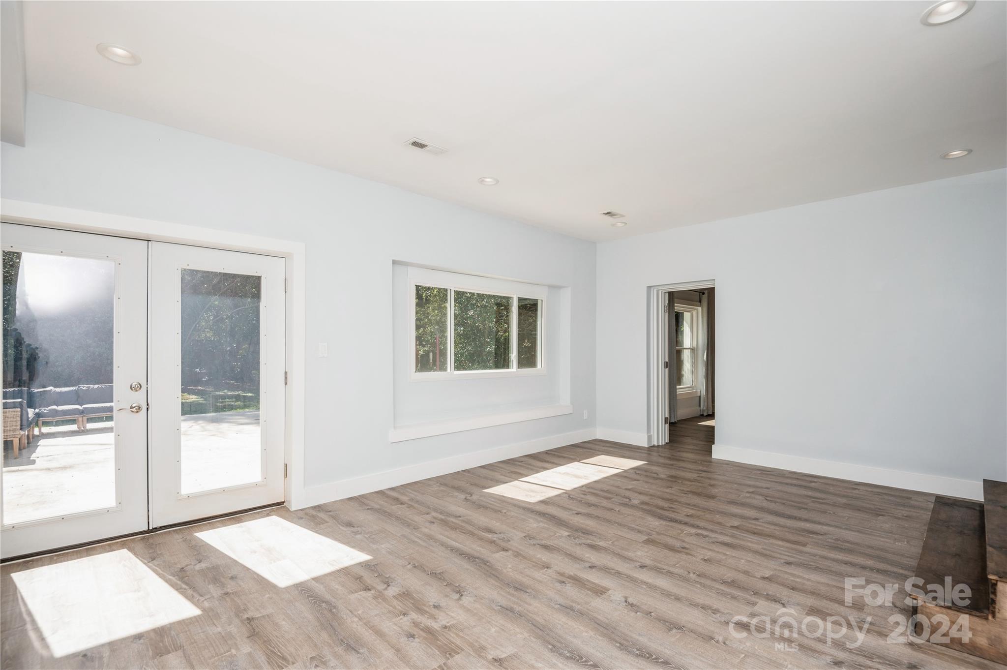 2124 Tyvola Road Charlotte, NC 28210 - Photo 9 of 38 a view of an empty room with wooden floor and a window