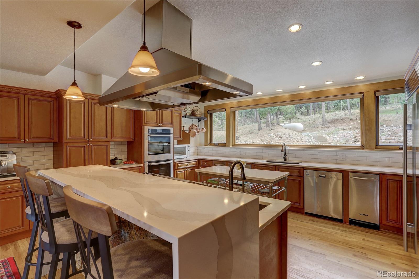 5886 Flagstaff Road Boulder, CO 80302 - Photo 11 of 37 a kitchen with stainless steel appliances granite countertop a sink a stove and a wooden floors