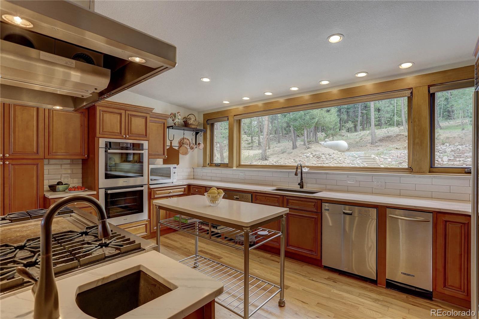 5886 Flagstaff Road Boulder, CO 80302 - Photo 12 of 37 a kitchen with a stove a sink and cabinets