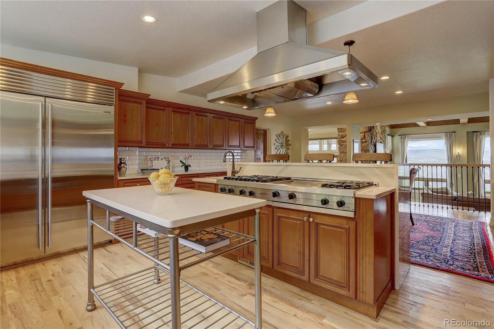 5886 Flagstaff Road Boulder, CO 80302 - Photo 13 of 37 a kitchen with kitchen island a stove a sink dishwasher and a refrigerator