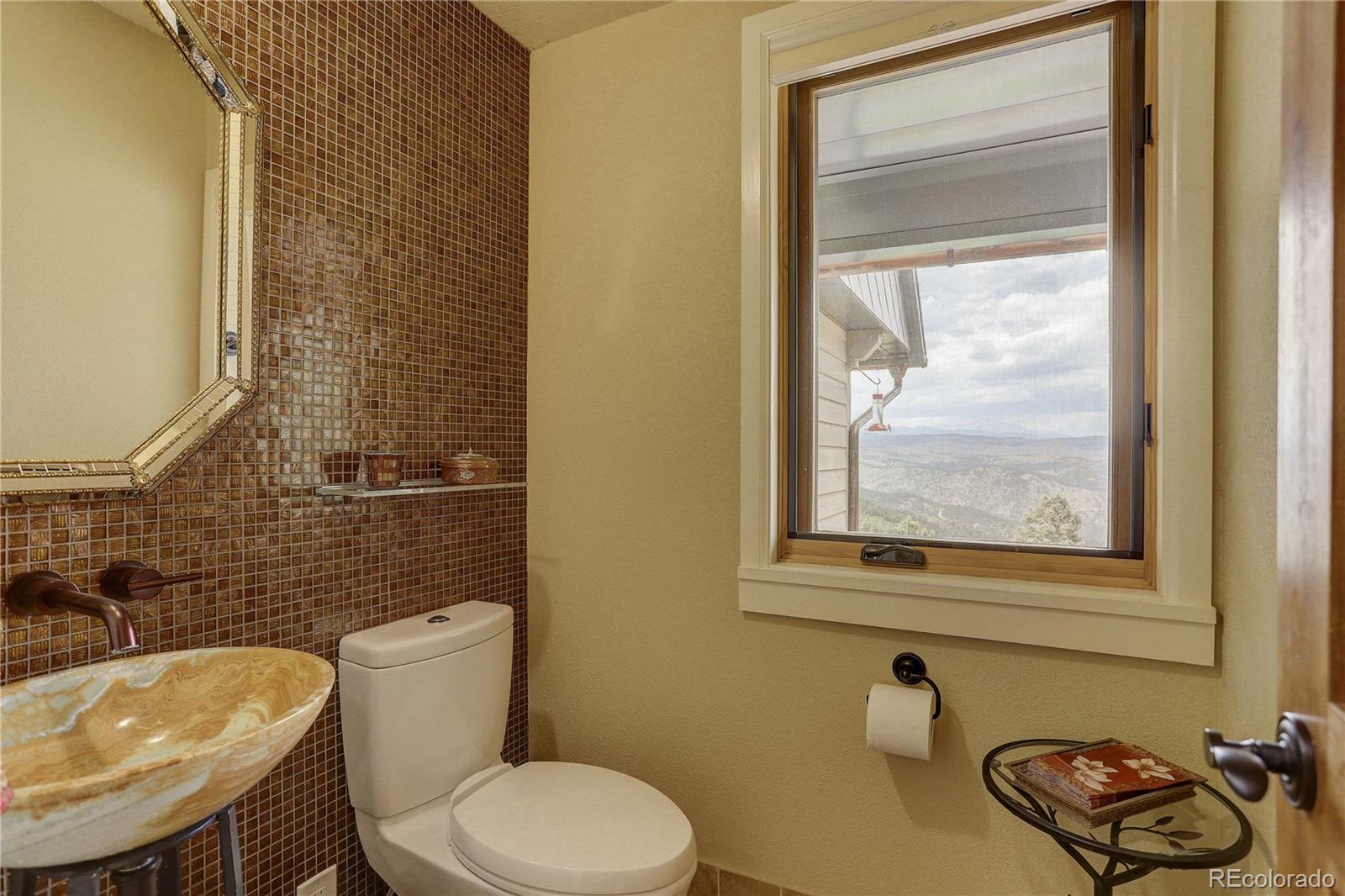 5886 Flagstaff Road Boulder, CO 80302 - Photo 16 of 37 a bathroom with a sink a toilet and a mirror