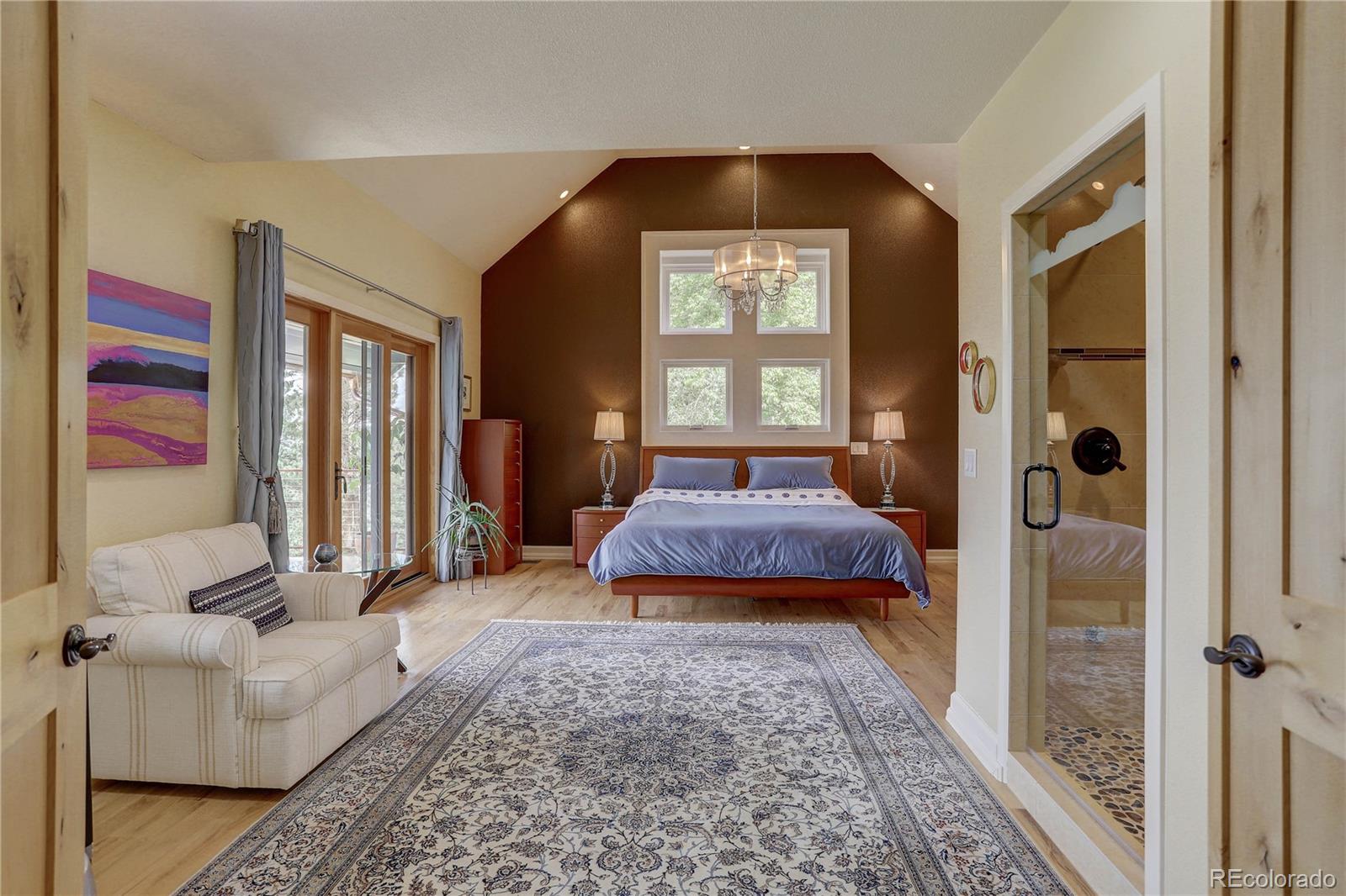 5886 Flagstaff Road Boulder, CO 80302 - Photo 17 of 37 a bedroom with a bed and a mirror