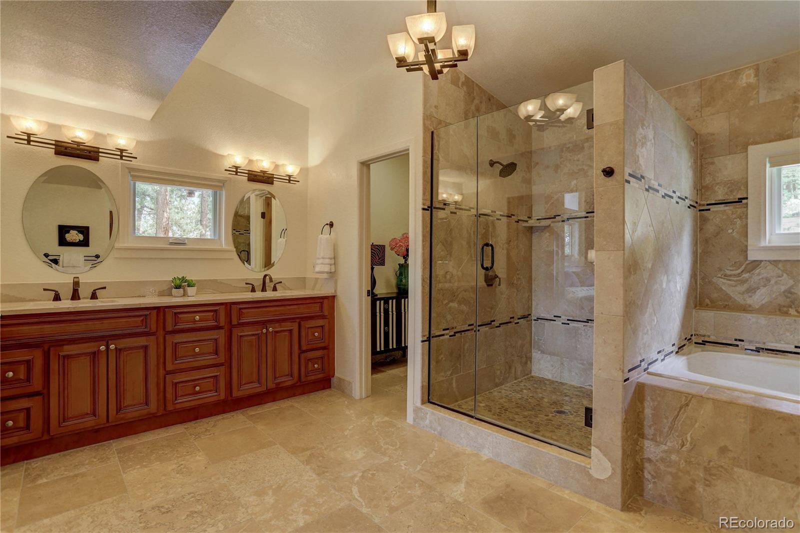 5886 Flagstaff Road Boulder, CO 80302 - Photo 21 of 37 a spacious bathroom with a granite countertop sink mirror and shower