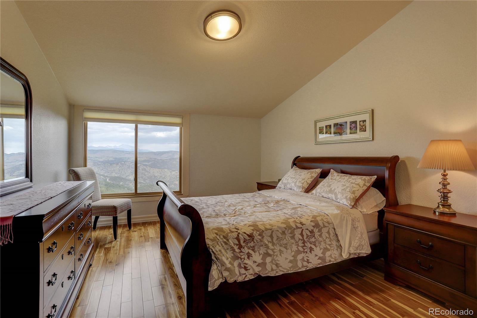5886 Flagstaff Road Boulder, CO 80302 - Photo 25 of 37 a bedroom with a bed and wooden floor