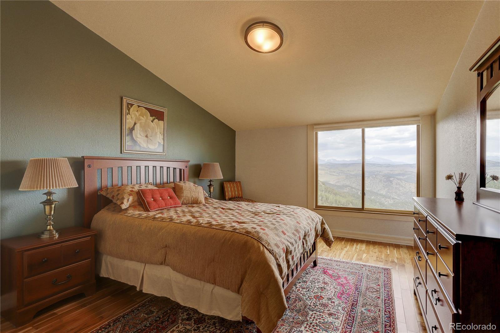 5886 Flagstaff Road Boulder, CO 80302 - Photo 27 of 37 a bed sitting in a bedroom next to a window