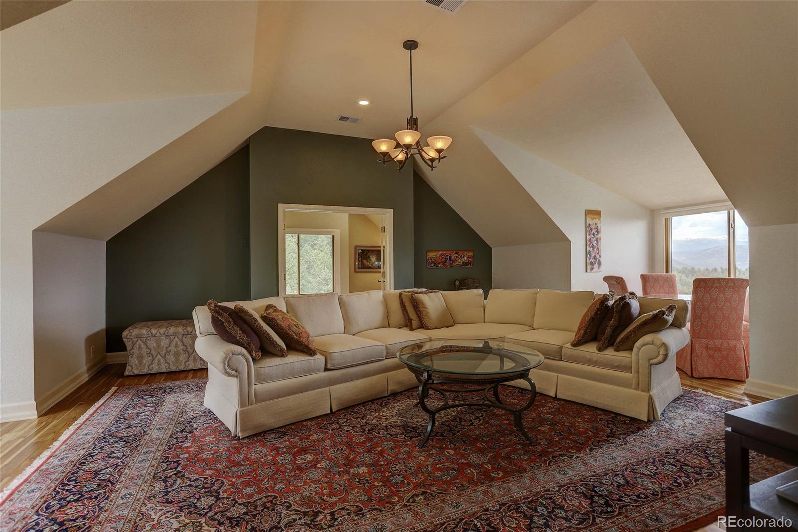 5886 Flagstaff Road Boulder, CO 80302 - Photo 28 of 37 a living room with furniture ceiling fan and a rug