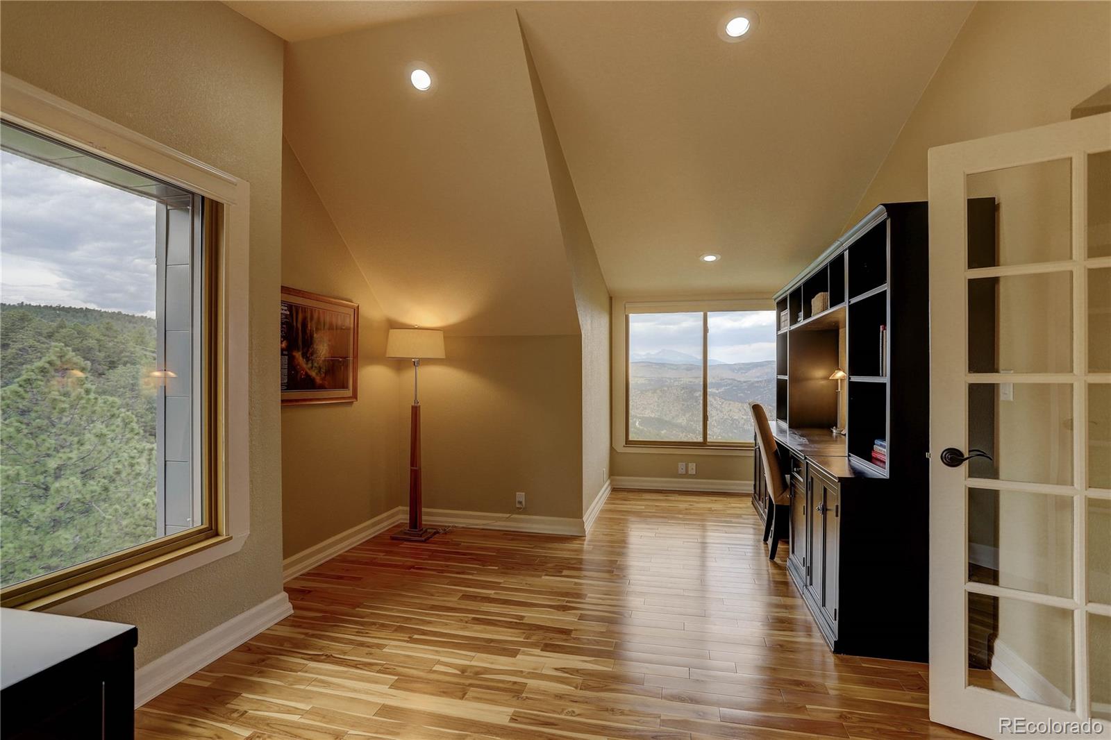 5886 Flagstaff Road Boulder, CO 80302 - Photo 29 of 37 a view of a hallway with wooden floor and staircase