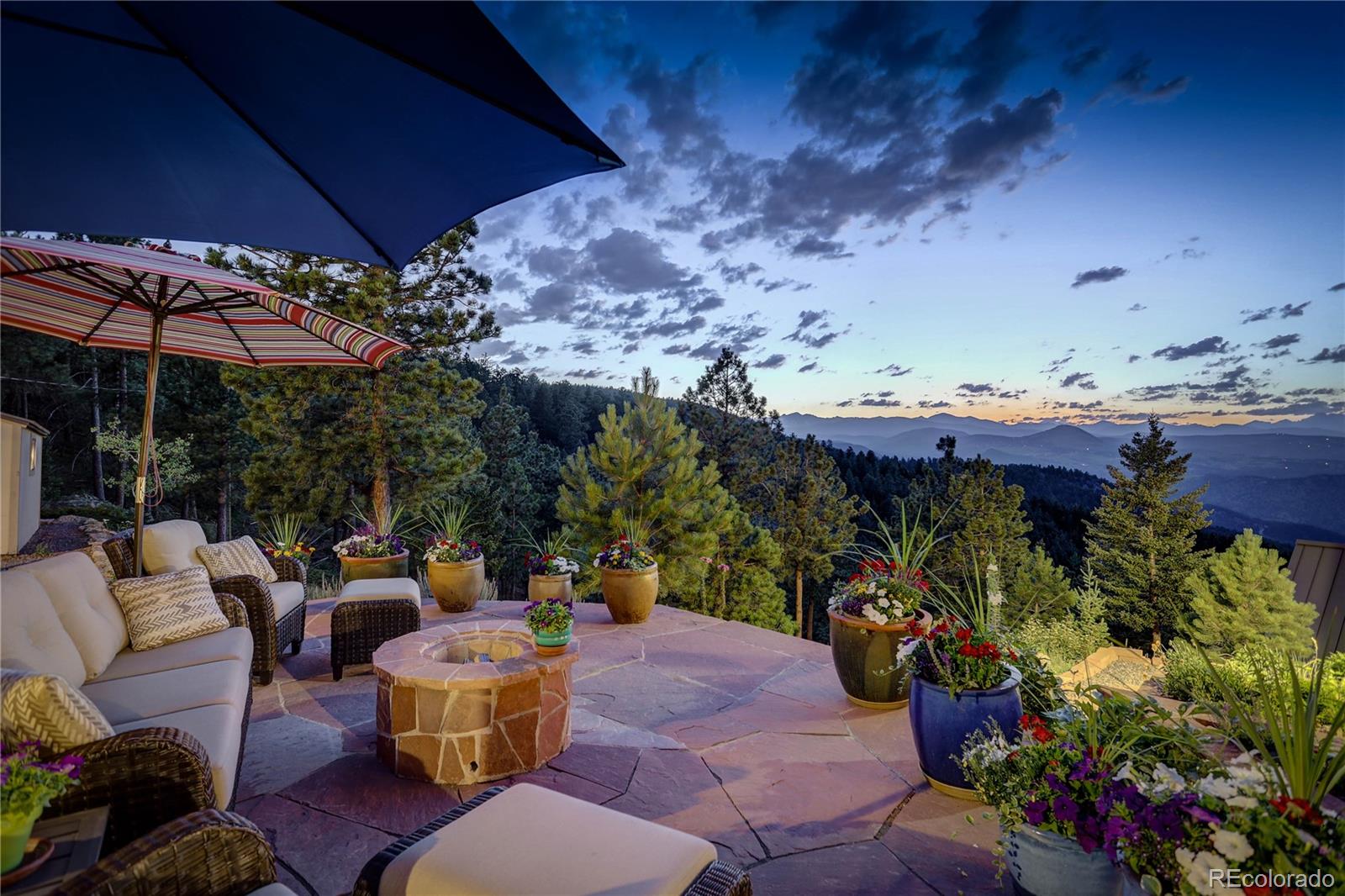 5886 Flagstaff Road Boulder, CO 80302 - Photo 34 of 37 a view of a patio with table and chairs under an umbrella