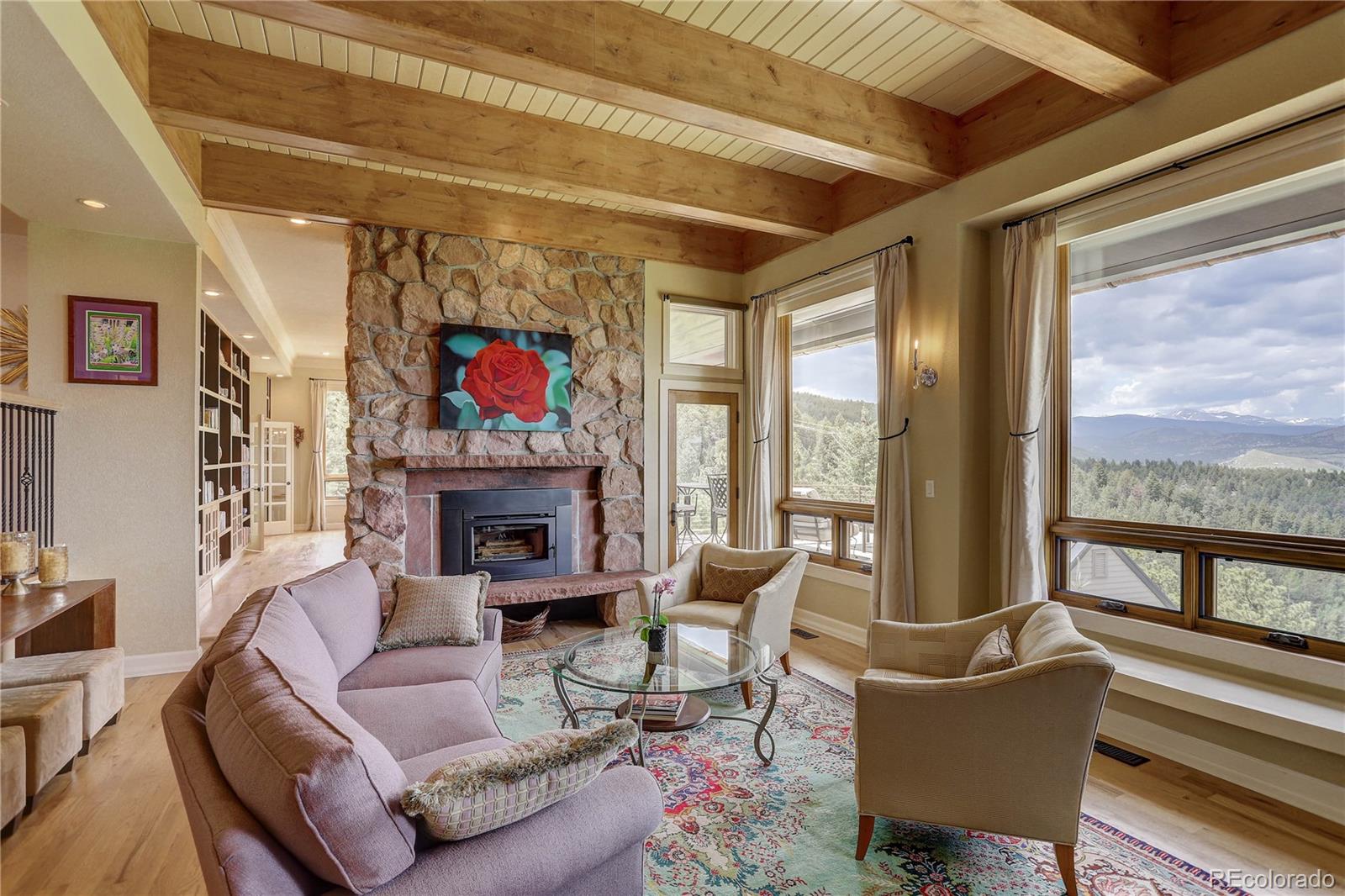 5886 Flagstaff Road Boulder, CO 80302 - Photo 6 of 37 a living room with furniture large windows and a fireplace