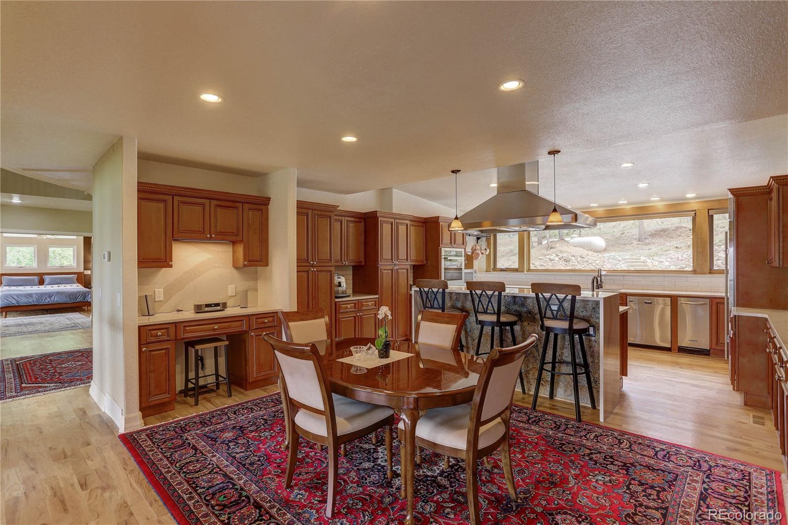 5886 Flagstaff Road Boulder, CO 80302 - Photo 10 of 37 a view of a dining room and livingroom with furniture wooden floor a rug and a chandelier