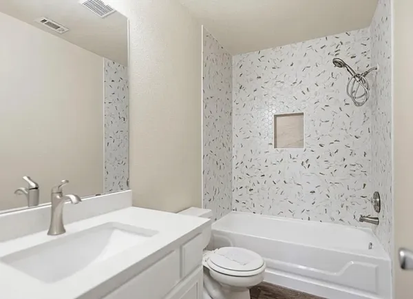 a bathroom with a sink toilet and shower