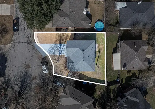 an aerial view of a house with a yard