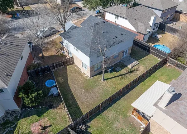 an aerial view of a house with a yard