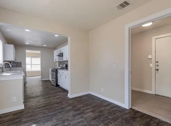 a view of a kitchen with a sink and a refrigerator