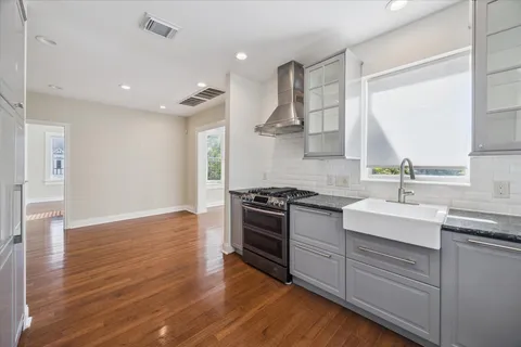 a view of a kitchen with wooden floor and a kitchen