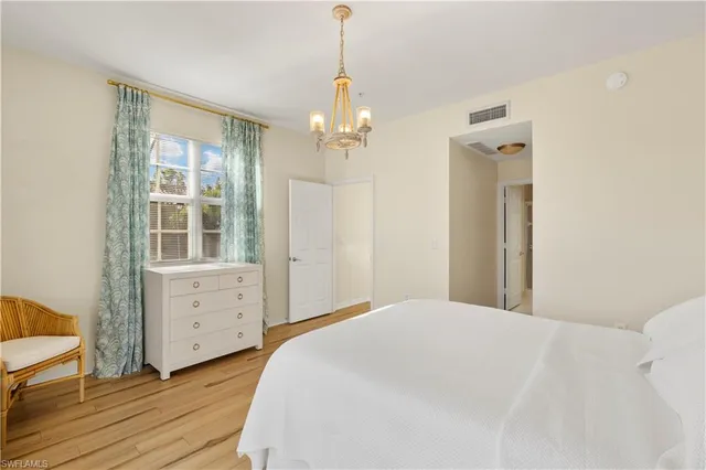 a bedroom with a bed dresser and a window