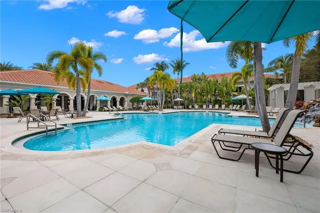 a view of a swimming pool with lounge chair