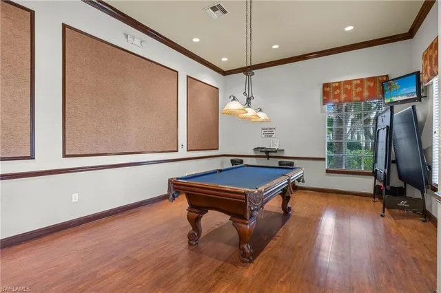 a room with wooden floor and furniture
