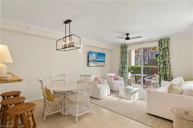 a living room with furniture a window and a chandelier