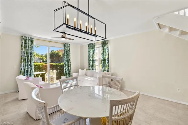 a dining room with furniture a rug and a large window
