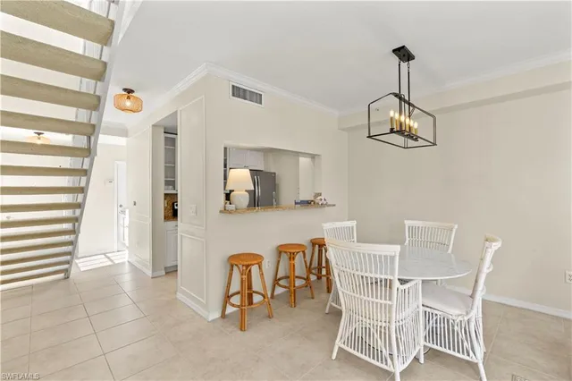 a view of a dining room with furniture and chandelier