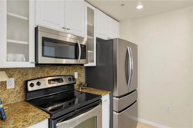 a kitchen with granite countertop cabinets and steel stainless steel appliances