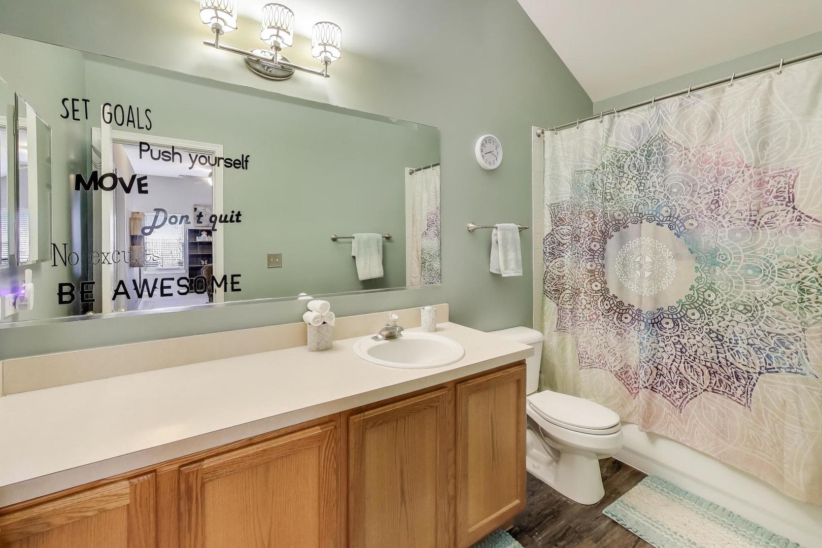 2487 Stonegate Road Algonquin, IL 60102 - Photo 22 of 39 a bathroom with a sink a toilet and shower