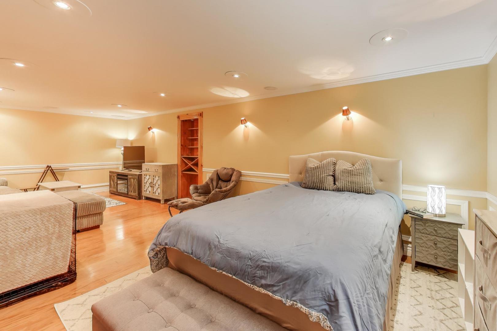 2487 Stonegate Road Algonquin, IL 60102 - Photo 28 of 39 a spacious bedroom with a bed and a view of living room