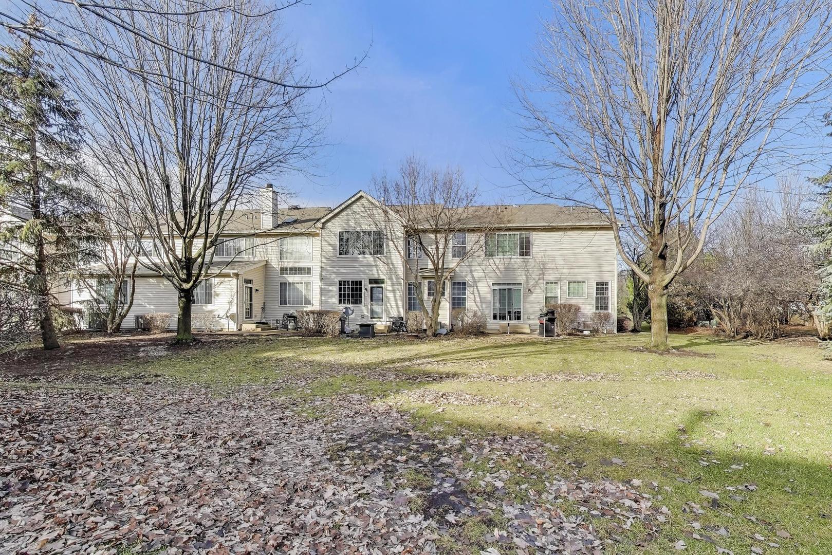 2487 Stonegate Road Algonquin, IL 60102 - Photo 34 of 39 a view of a big house with a big yard and large trees