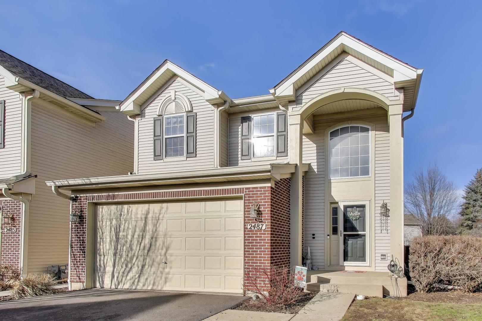 2487 Stonegate Road Algonquin, IL 60102 - Photo 36 of 39 a front view of a house with a yard