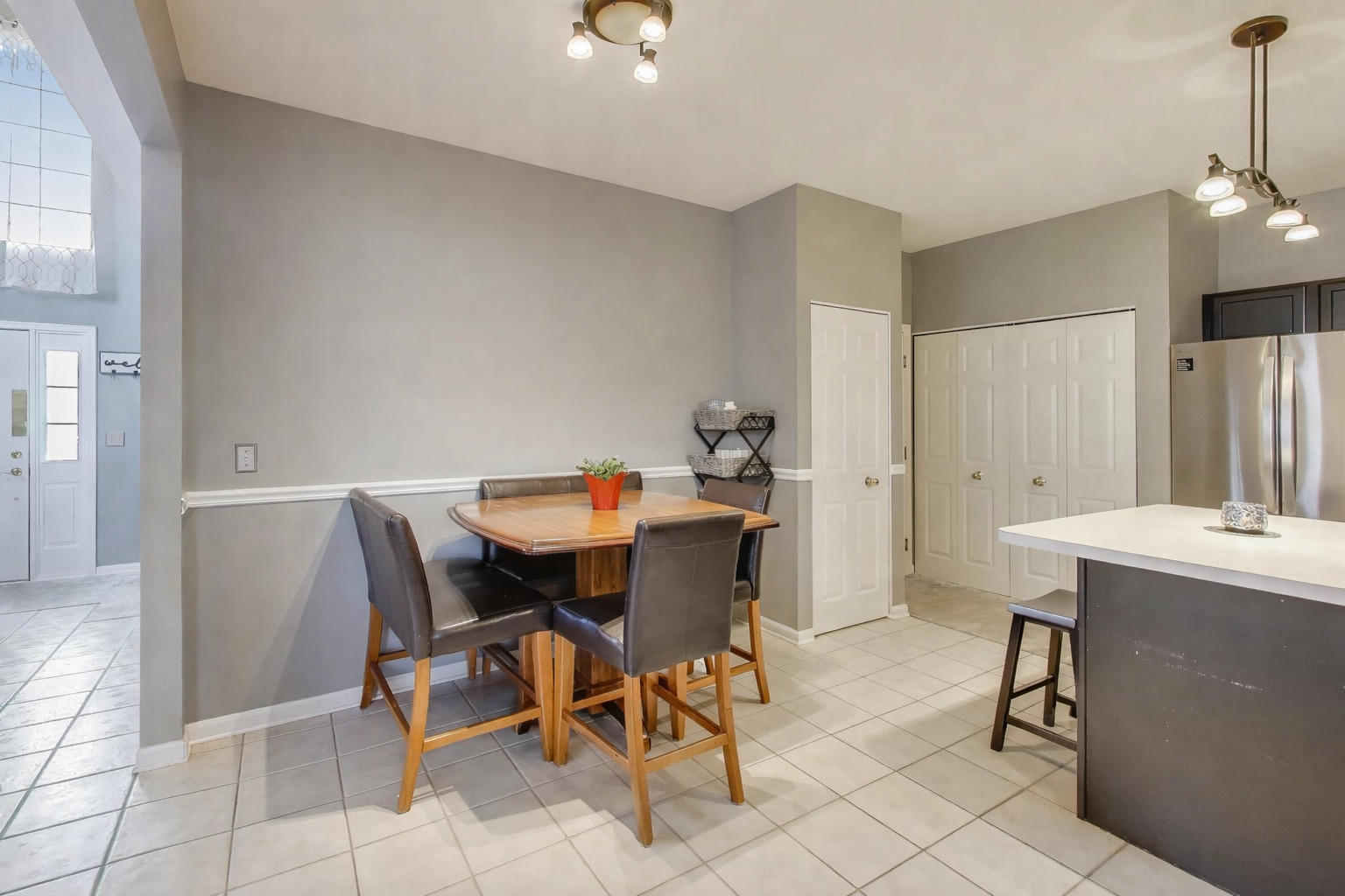 2487 Stonegate Road Algonquin, IL 60102 - Photo 5 of 39 a view of a dining room with furniture and a chandelier