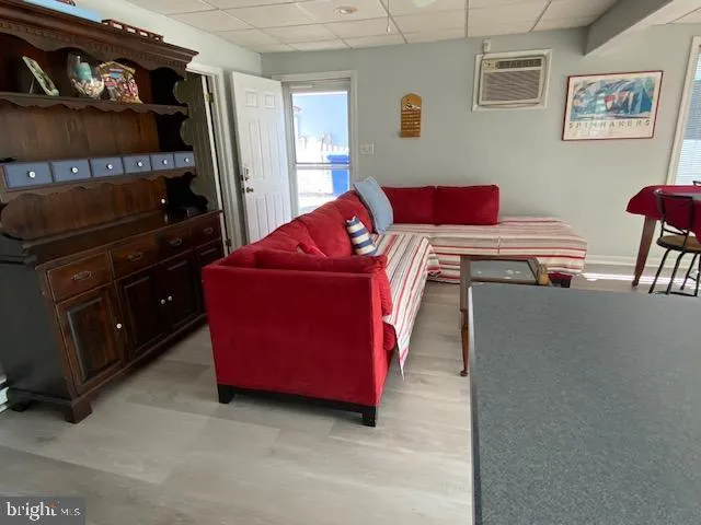 a living room with furniture and a dresser