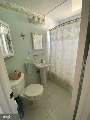 a white toilet sitting next to a bathroom sink