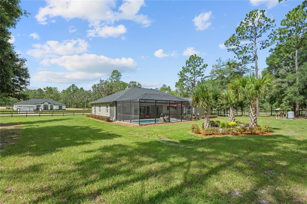 12929 Southwest 89th Street Dunnellon, FL 34432 - Photo 53 of 76 a view of a house with a big yard and large trees