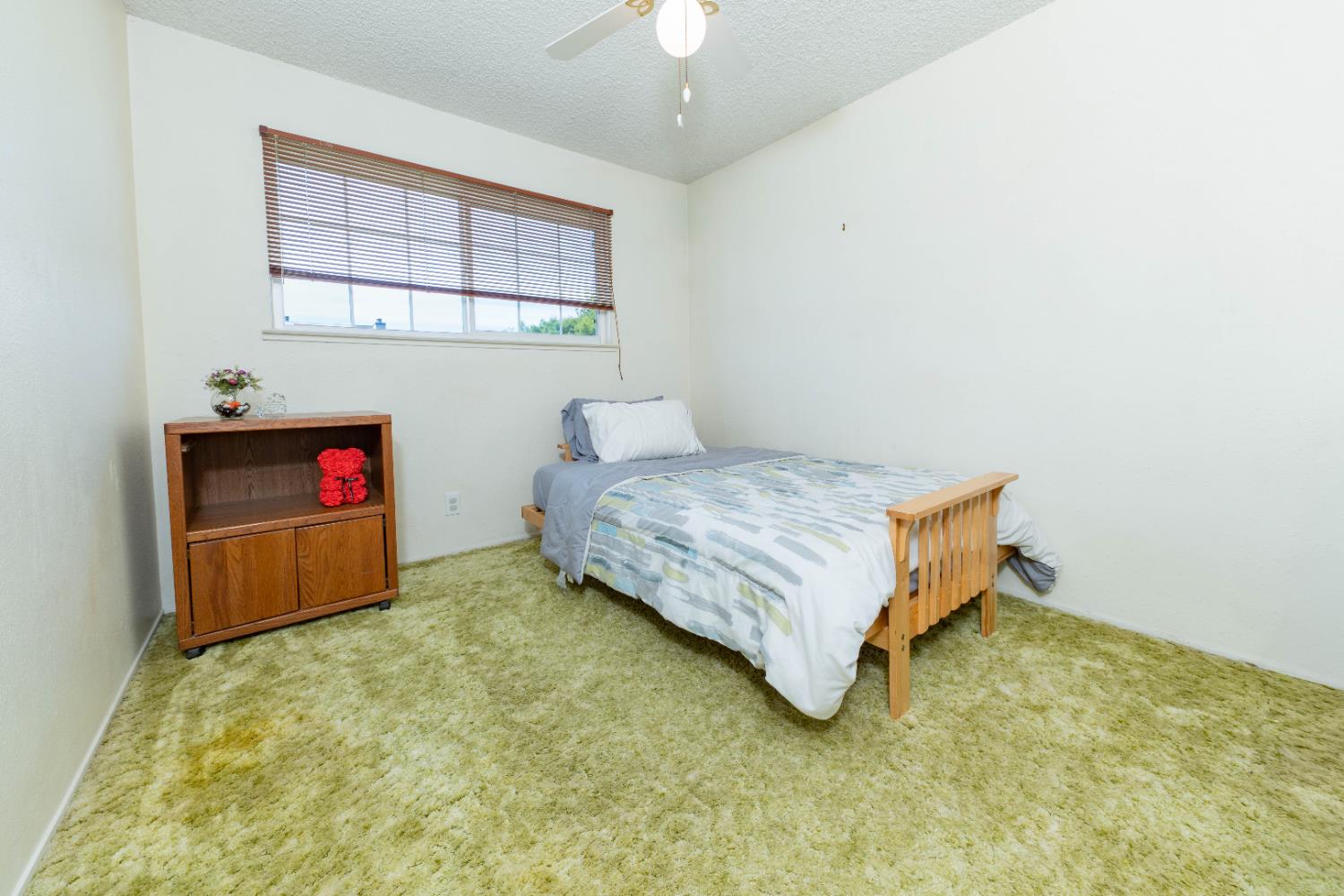 876 Daphne Lane Lemoore, CA 93245 - Photo 11 of 19 a bedroom with a bed and a chandelier