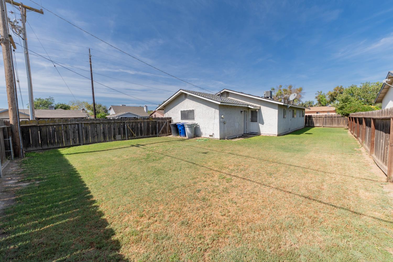 876 Daphne Lane Lemoore, CA 93245 - Photo 15 of 19 a view of a house with backyard and sitting area