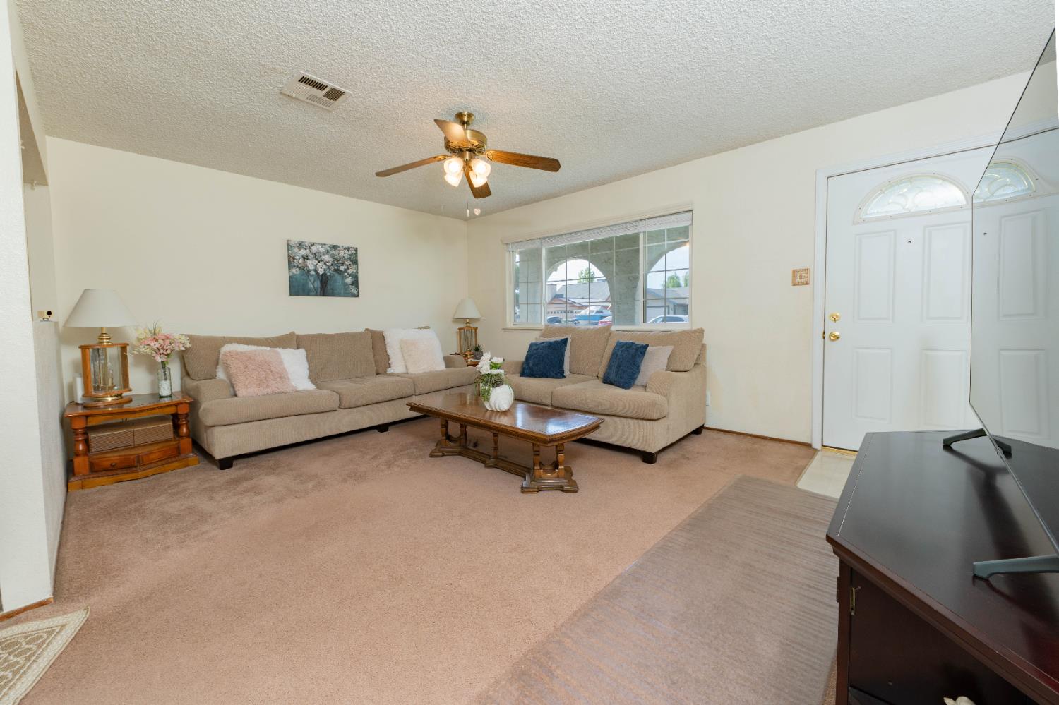 876 Daphne Lane Lemoore, CA 93245 - Photo 4 of 19 a living room with furniture and a large window