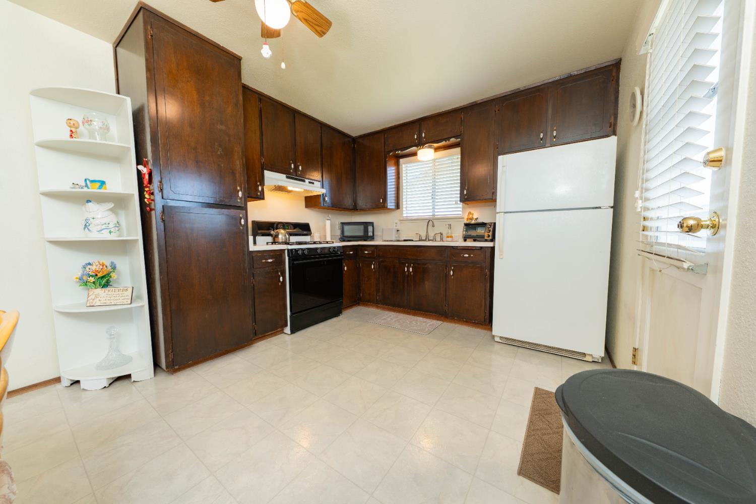 876 Daphne Lane Lemoore, CA 93245 - Photo 7 of 19 a kitchen with refrigerator and window