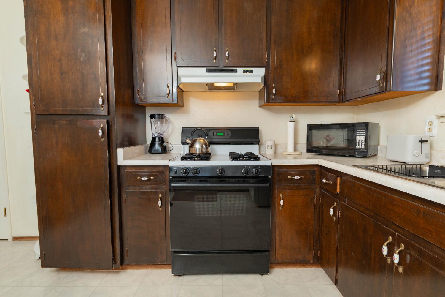 876 Daphne Lane Lemoore, CA 93245 - Photo 8 of 19 a kitchen with stainless steel appliances granite countertop a stove a refrigerator and a sink