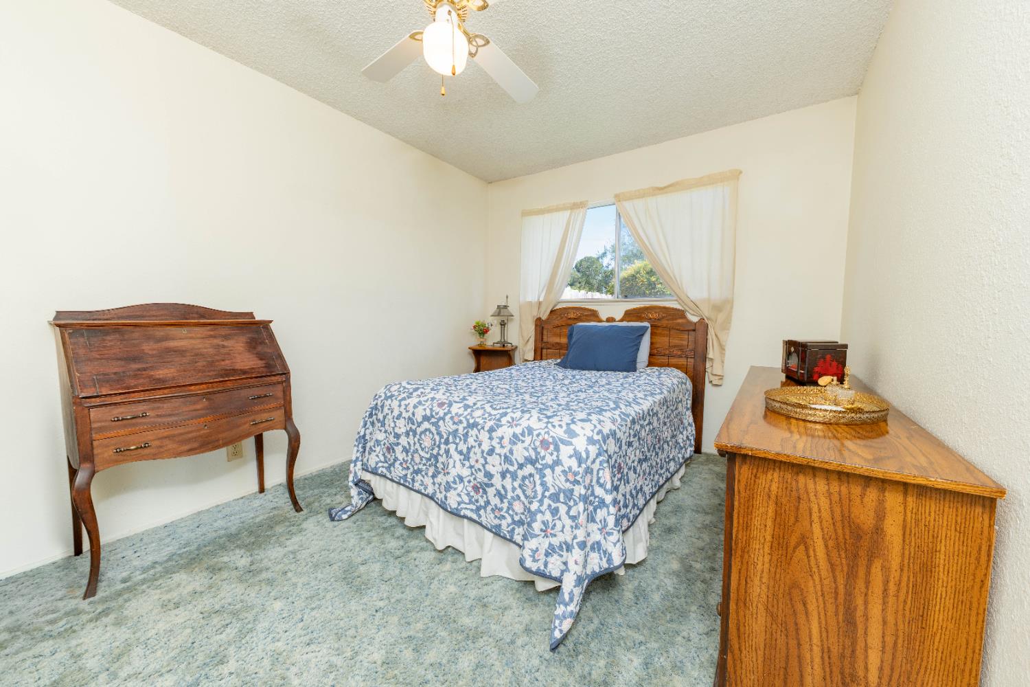 876 Daphne Lane Lemoore, CA 93245 - Photo 9 of 19 a living room with a couch and a chandelier