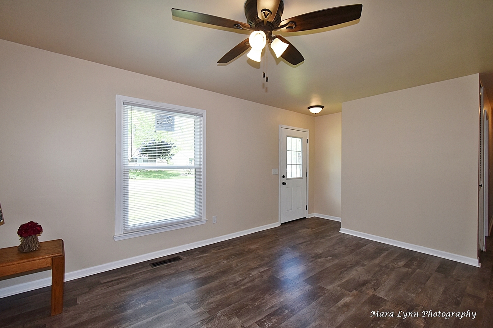 57 Sheffield Road Montgomery, IL 60538 - Photo 8 of 24 a view of an empty room with wooden floor and a window