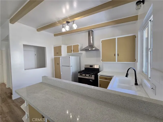 a kitchen with kitchen island granite countertop a sink cabinets and stainless steel appliances
