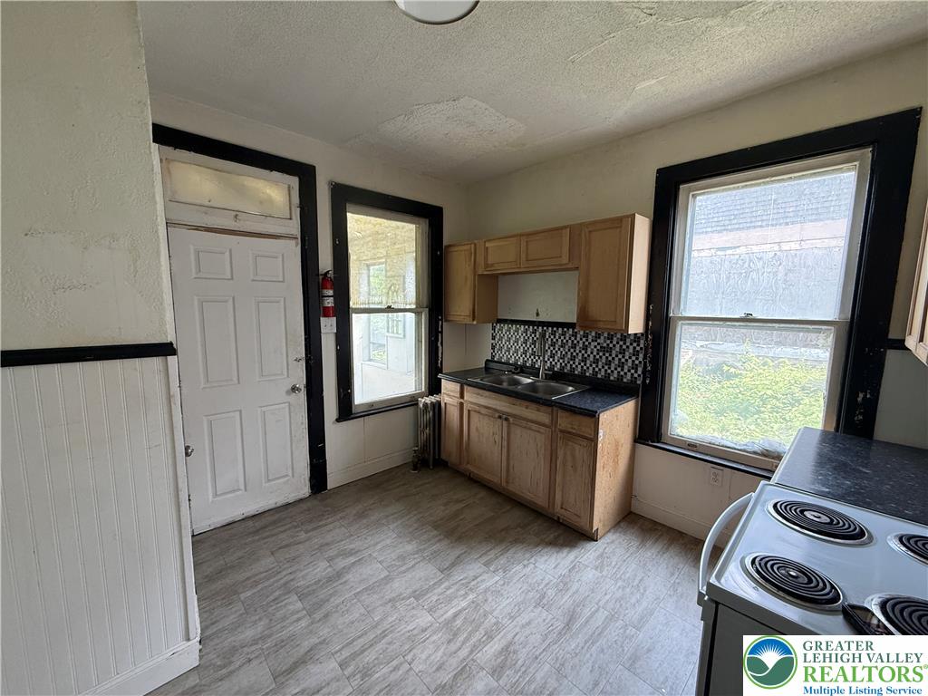 41 West Ridge Street Lansford, PA 18232 - Photo 11 of 40 Functional kitchen with ample cabinetry and essential appliances awaits your personal touch.