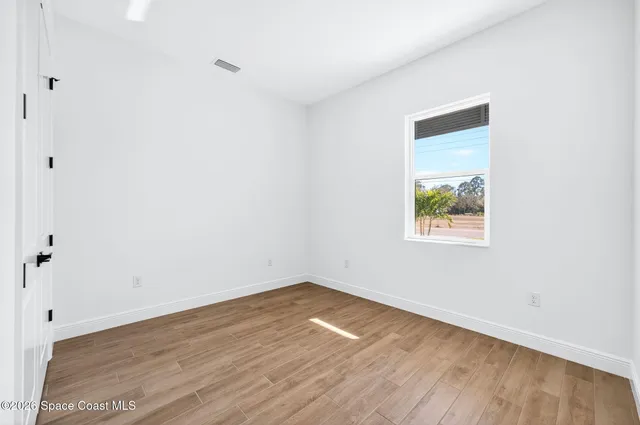 a view of a room with wooden floor