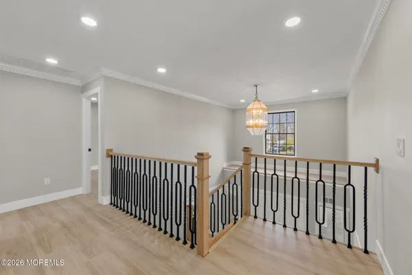 a view of a hallway with windows and stairs