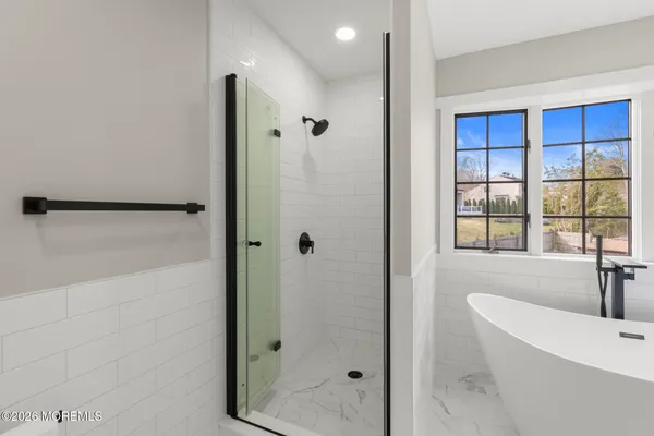 a bathroom with a bathtub and a shower