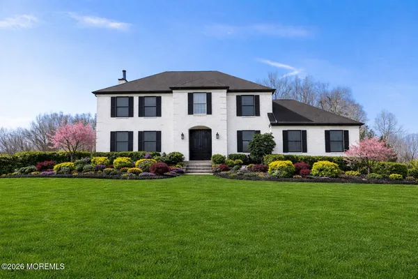 a view of a house with garden and yard