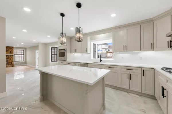 a kitchen with counter top space cabinets and appliances