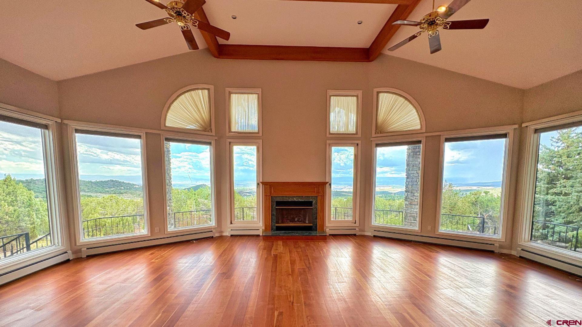 20508 Green Valley Road Cedaredge, CO 81413 - Photo 11 of 42 a view of empty room with wooden floor and fireplace